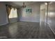 Open living room with wood-look tile floors, chandelier, and abundant natural light at 4255 E Rock Dr, San Tan Valley, AZ 85143