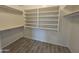 Spacious walk-in closet with white built-in shelving and wood-look tile flooring at 4255 E Rock Dr, San Tan Valley, AZ 85143