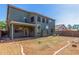 View of the home's backyard and covered patio, showcasing the landscaped yard at 45080 W Buckhorn Trl, Maricopa, AZ 85139