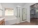 Bright bathroom featuring a shower, tub and view into the walk-in closet at 45080 W Buckhorn Trl, Maricopa, AZ 85139