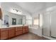 Bathroom featuring a double vanity, separate shower, and tub under a window at 45080 W Buckhorn Trl, Maricopa, AZ 85139