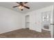 Bright bedroom with neutral carpet and natural light, featuring closet and upstairs landing at 45080 W Buckhorn Trl, Maricopa, AZ 85139
