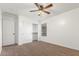 Bedroom featuring neutral carpet, ceiling fan, and an open closet at 45080 W Buckhorn Trl, Maricopa, AZ 85139