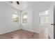 Bright bedroom with two windows and tile flooring for added comfort at 45080 W Buckhorn Trl, Maricopa, AZ 85139