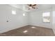 Bedroom featuring carpeted floors, a ceiling fan and a window with natural light at 45080 W Buckhorn Trl, Maricopa, AZ 85139