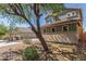 Two-story home with a lovely two-tone green exterior, a red tile roof, a well-manicured yard, and a two-car garage at 45080 W Buckhorn Trl, Maricopa, AZ 85139
