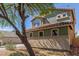 Two-story home with a lovely two-tone green exterior, a red tile roof, and a well-manicured yard at 45080 W Buckhorn Trl, Maricopa, AZ 85139