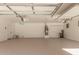 Spacious garage with epoxy flooring, water heater, and ample storage space at 45080 W Buckhorn Trl, Maricopa, AZ 85139