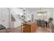 Well-lit kitchen with an island, stainless steel appliances, a staircase, and tile flooring for easy maintenance at 45080 W Buckhorn Trl, Maricopa, AZ 85139