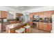 Bright kitchen featuring stainless steel appliances, an island, granite countertops, and tile flooring at 45080 W Buckhorn Trl, Maricopa, AZ 85139