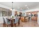 Well-lit kitchen with an island, stainless steel appliances, a dining table, and tile flooring for easy maintenance at 45080 W Buckhorn Trl, Maricopa, AZ 85139