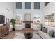 Bright living room with vaulted ceiling, fireplace, modern decor, and lots of natural light at 45080 W Buckhorn Trl, Maricopa, AZ 85139