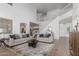 Spacious living room with neutral colors, a staircase in the background, and an arched doorway at 45080 W Buckhorn Trl, Maricopa, AZ 85139