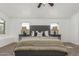 Comfortable main bedroom with a ceiling fan, carpet flooring, and bright windows at 45080 W Buckhorn Trl, Maricopa, AZ 85139
