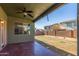 Outdoor patio featuring a ceiling fan, view of the backyard, and mature landscaping at 45080 W Buckhorn Trl, Maricopa, AZ 85139