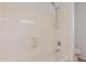 A clean shower featuring a fixed shower head, handset, and a white surround at 45080 W Buckhorn Trl, Maricopa, AZ 85139