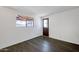 Bedroom featuring modern laminate flooring, a window view, and a doorway at 501 E Alameda Dr, Tempe, AZ 85282