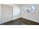 Bedroom featuring modern laminate flooring, a double-door closet, and a window view at 501 E Alameda Dr, Tempe, AZ 85282
