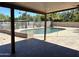Covered back patio overlooking a fenced pool area with mature trees and landscaping at 5514 E Pershing Ave, Scottsdale, AZ 85254