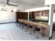 Open concept kitchen with granite countertops, dark wood cabinets, and bar seating at 5514 E Pershing Ave, Scottsdale, AZ 85254
