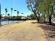 View of tennis court surrounded by desert landscaping and mature trees at 5514 E Pershing Ave, Scottsdale, AZ 85254