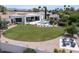Aerial view of the property showcases lush landscaping, a pool, and multiple outdoor seating areas at 6443 E Malcomb Dr, Paradise Valley, AZ 85253