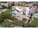 Aerial view of a sprawling estate, showcasing the pool, sport court, lush landscaping, and multiple structures at 6443 E Malcomb Dr, Paradise Valley, AZ 85253