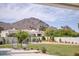 Expansive backyard boasts a grassy area, mountain views, and comfortable seating areas for outdoor relaxation at 6443 E Malcomb Dr, Paradise Valley, AZ 85253