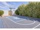 Basketball court surrounded by greenery and a privacy wall at 6443 E Malcomb Dr, Paradise Valley, AZ 85253