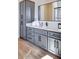 Modern bathroom featuring sleek gray cabinetry, black hardware, and a large mirror above the vanity at 6443 E Malcomb Dr, Paradise Valley, AZ 85253