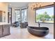 Modern bathroom showcasing a freestanding tub with black fixtures and a picturesque window view at 6443 E Malcomb Dr, Paradise Valley, AZ 85253