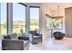 Bright bathroom featuring a large window with mountain views, modern chairs, and a standalone tub at 6443 E Malcomb Dr, Paradise Valley, AZ 85253