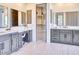 Elegant bathroom with double vanity, makeup station and walk-in closet with custom shelving at 6443 E Malcomb Dr, Paradise Valley, AZ 85253