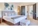 Spacious bedroom with neutral decor, a large bed with decorative pillows, and views into the rest of the house at 6443 E Malcomb Dr, Paradise Valley, AZ 85253