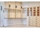 Spacious walk-in closet with custom shelving, drawers and hanging space for clothing and accessories at 6443 E Malcomb Dr, Paradise Valley, AZ 85253