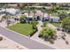 Elegant home with palm trees, green lawn and circular driveway at 6443 E Malcomb Dr, Paradise Valley, AZ 85253