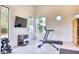 Well equipped home gym featuring a sauna, treadmill, weights and mounted tv at 6443 E Malcomb Dr, Paradise Valley, AZ 85253