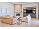Comfortable living room featuring a stone fireplace, custom built-ins, and hardwood floors at 6443 E Malcomb Dr, Paradise Valley, AZ 85253