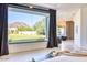 Bright bedroom featuring large window with backyard views, and hardwood floors at 6443 E Malcomb Dr, Paradise Valley, AZ 85253