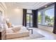 Bright main bedroom with a large window overlooking the backyard and a cozy seating area at 6443 E Malcomb Dr, Paradise Valley, AZ 85253