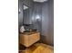 Stylish powder room featuring a vessel sink and modern, vertical wood paneling and unique faucet at 6443 E Malcomb Dr, Paradise Valley, AZ 85253