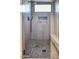 Contemporary shower featuring pebble flooring, a built-in bench, and a sleek rainfall showerhead at 6443 E Malcomb Dr, Paradise Valley, AZ 85253