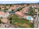 Stunning aerial shot of a neighborhood featuring a home with an in-ground pool and a spacious lawn at 665 S Balboa --, Mesa, AZ 85206