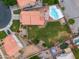 Aerial view of a home with a tile roof, large backyard and swimming pool surrounded by well-manicured landscaping at 665 S Balboa --, Mesa, AZ 85206