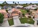 Aerial view of a home with a tile roof, an in-ground pool and a well-manicured front yard at 665 S Balboa --, Mesa, AZ 85206