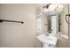 Well-lit half bathroom with pedestal sink and stylish mirror, designed for convenience and elegance at 665 S Balboa --, Mesa, AZ 85206