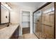 Bathroom with a granite-topped dark wood vanity and glass shower, exuding modern style and comfort at 665 S Balboa --, Mesa, AZ 85206