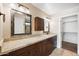 Bathroom with double mirrors, granite counters, and dark wood cabinets offering style and functionality at 665 S Balboa --, Mesa, AZ 85206