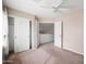 This bedroom has a ceiling fan and a closet with white doors and a view of the home's interior at 665 S Balboa --, Mesa, AZ 85206