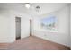 This bedroom features neutral carpet, a ceiling fan, and a closet with white doors at 665 S Balboa --, Mesa, AZ 85206